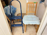 Blue metal two-step stool and pine chair with striped cushion