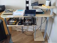 Front view showing desk surfaces, monitor shelf, keyboard tray