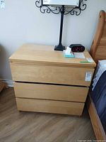 Front view showing three drawers and overall finish