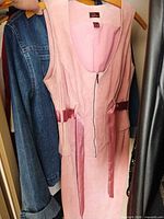 Full view of pink sleeveless suede dress on hanger
