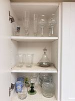cabinet view showing multiple glasses and covered dish