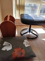 Footstool, magazine rack, pillow grouped