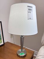 Full view of lamp on table showing shade and base with measuring sticker