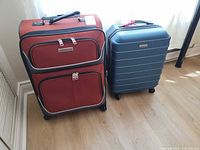 Both suitcases side by side showing size and style