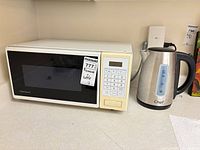 Kenmore microwave and Masterchef kettle on countertop