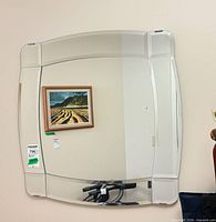 Front view of square beveled mirror mounted on wall
