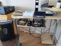 Overall view showing desk, trays, paper, lamp, math set, shredder visible