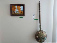 Painting and bed warmer hanging on wall