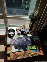 Overall lot showing pewter bowl, dolls, paintings, candle molds and ceramic shoes