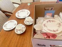 Teacups, saucers, plates on table and boxed pieces