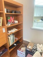 Full view of teak veneer shelving unit showing multiple shelves and side panel