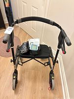 Front view of Nexus walker with blood pressure monitor resting on seat