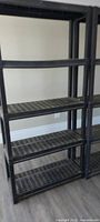 Full view of both plastic shelving units showing five shelves each