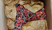 Open box filled with red-cap nails