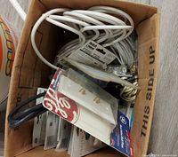 Overview of box showing assorted cables, packaged connectors, wall plate