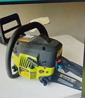 Top and side view of Poulan chainsaw showing overall design and controls