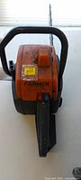 Orange Farmer chainsaw top view