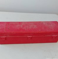 closed red carrying case top view showing molded brand and text