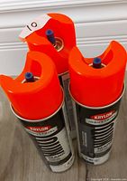 Three Krylon Industrial Quik-Mark cans grouped, showing orange caps and overall condition