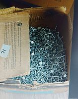 Open box filled with roofing nails