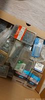 Overview of box showing various packaged nails and screws