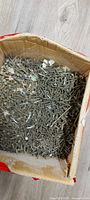 top view of cardboard box filled with mixed screws