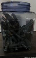 Square clear jar filled with screws
