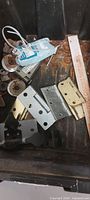 Black tray interior showing loose hinges, washers and brackets