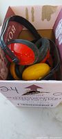 Red and yellow earmuffs in box