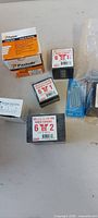 Multiple boxes of Paslode nails and wood screw boxes