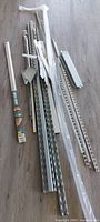 bundle of galvanized tracks, trim strips, packaged piece and connectors on floor
