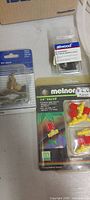 Close-up of packaged Melnor valve kit, brass tap valve and rubber grommet pack