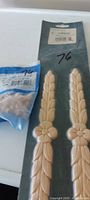 Overall lot showing sealed molding trims package and bag of wood buttons