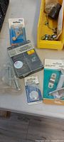 Packaged corner brace, magnetic latch, hinge, screws visible on table