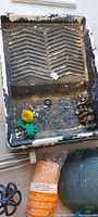 paint tray interior showing wear and miscellaneous small parts