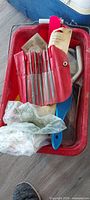 Red pail with file set, scraper, packaged items