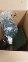 Box showing brush, green pad, bagged cords