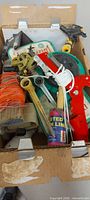 box containing sprinklers, cutter, level, hose guide packaging, lines