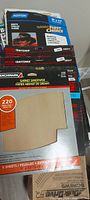 Stack of Benchmark, Craftsman, Norton sandpaper packs