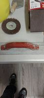 Wire wheel, sandpaper sheets, sanding block handle with partial yellow pail