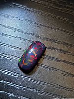 Top view of the black opal showing multicolour fire