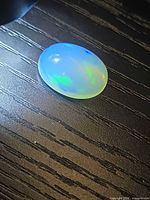 Top view of opal displaying blue and green flashes