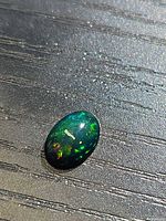Front view of the black opal showing play of color