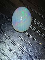 Front view of oval Ethiopian opal showing play of color
