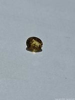 Front view of yellow sapphire showing oval cut and colour