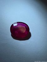 Front view of oval ruby showing colour and facets