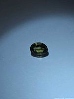 Front view of oval yellow-green tourmaline