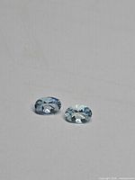 Pair of loose aquamarines on neutral background