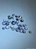 Group of loose faceted tanzanite stones on white background