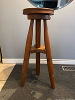 full view of wooden tripod stool front